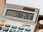 Tax word and 2018 number on calculator. Business and tax concept. Pay tax in 2018 years.