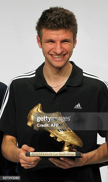 Germany's striker Thomas Mueller, Golden Boot winner, poses with his award during the FIFA Soccer World Cup 2010 award ceremony at the headquarters...