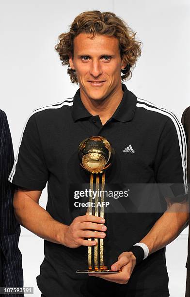 Uruguay's striker Diego Forlan,Golden Ball winner, poses with his award during the FIFA Soccer World Cup 2010 award ceremony at the headquarters of...