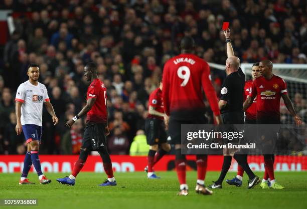 Eric Bailly of Manchester United is shown a red card and is sent off by referee Lee Mason during the Premier League match between Manchester United...