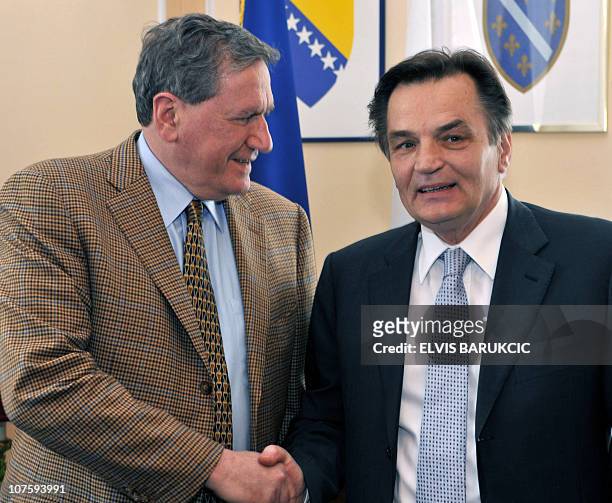 Former US diplomat Richard Holbrooke and President of Bosnia's tri-partite presidency, Haris Silajdzic shake hands, in Sarajevo, during Holbrooke's...