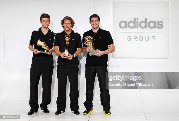 Thomas Mueller, adidas Golden Boot Winner, Diego Forlan, adidas Golden Ball Winner, and Iker Casillas, adidas Golden Glove Winner pose with their...