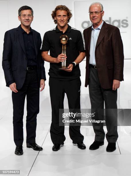 Herbert Hainer, the adidas Group CEO, Diego Forlan, adidas Golden Ball Winner and FIFA executive committee member Franz Beckenbauer pose during the...