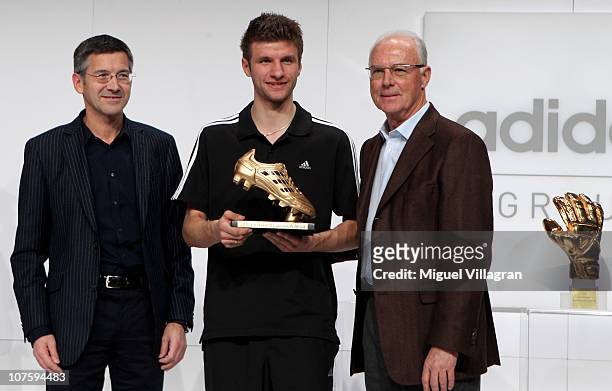 Herbert Hainer, the adidas Group CEO, Thomas Mueller, adidas Golden Boot Winner and FIFA executive committee member Franz Beckenbauer pose during the...