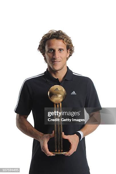 Diego Forlan of Uruguay poses with the adidas Golden Ball Winner Trophy at the adidas HQ on December 14, 2010 in Herzogenaurach, Germany.