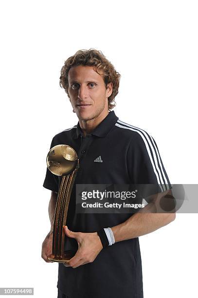 Diego Forlan of Uruguay poses with the adidas Golden Ball Winner Trophy at the adidas HQ on December 14, 2010 in Herzogenaurach, Germany.