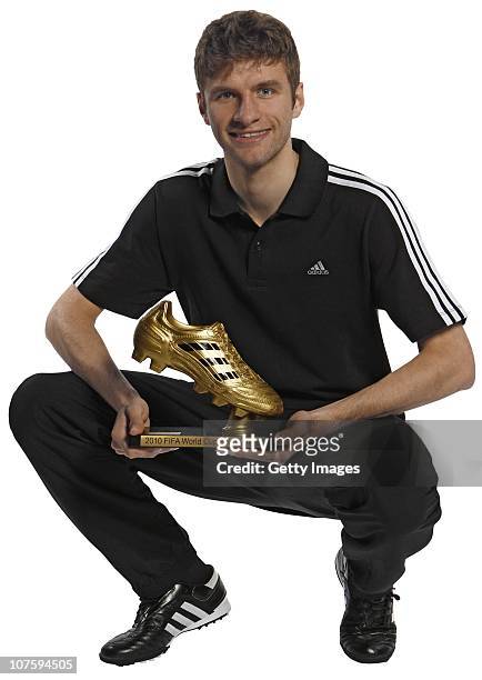 Thomas Mueller of Germany poses with the adidas Golden Boot Winner Trophy at the adidas HQ on December 14, 2010 in Herzogenaurach, Germany.