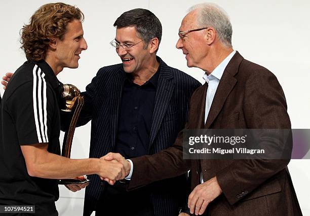 Herbert Hainer , the adidas Group CEO, and FIFA executive committee member Franz Beckenbauer hand over the adidas Golden Ball award to Diego Forlan...
