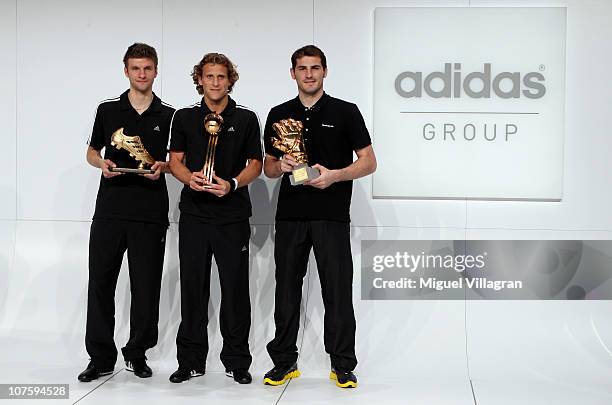 Thomas Mueller, adidas Golden Boot Winner, Diego Forlan, adidas Golden Ball Winner and Iker Casillas, adidas Golden Glove Winner pose with their FIFA...