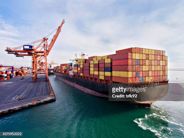 aerial view of cargo ship in transit. - ship stock pictures, royalty-free photos & images