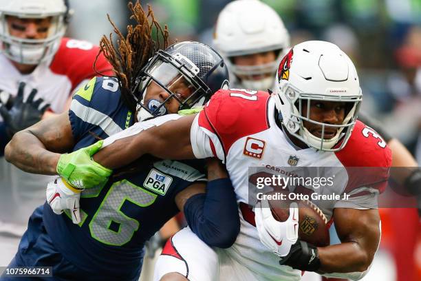 Shaquill Griffin of the Seattle Seahawks tackles David Johnson of the Arizona Cardinals to prevent a first down during the 1st qwaurter at...