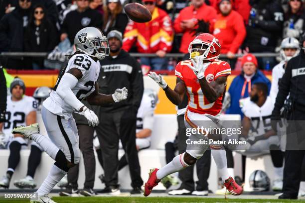 Tyreek Hill of the Kansas City Chiefs catches a pass in front of Nick Nelson of the Oakland Raiders that would lead to the games first touchdown...