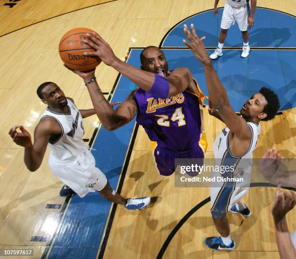 Kobe Bryant of the Los Angeles Lakers shoots against Gilbert Arenas and Nick Young of the Washington Wizards at the Verizon Center on December 14,...