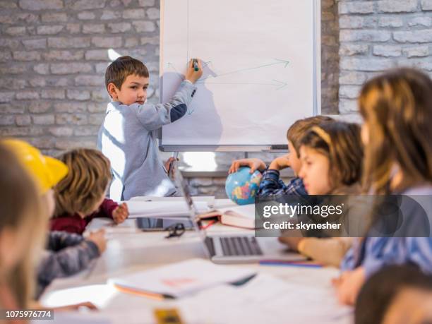 small business boy giving presentation to his friends in the office. - kid presenting stock pictures, royalty-free photos & images