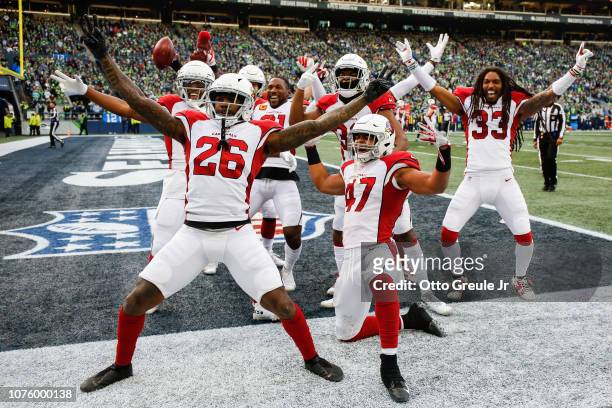 Brandon Williams and Zeke Turner and other members of the Arizona Cardinals celebrate after tying the score in the third quarter against the Seattle...