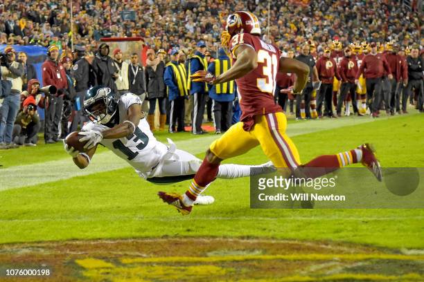 Nelson Agholor of the Philadelphia Eagles dives for a touchdown in front of Fabian Moreau of the Washington Redskins during the second half at...
