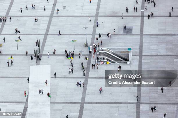 crowds of people walking on the city square in la defense - business financial district, paris, france - aerial walking stock pictures, royalty-free photos & images