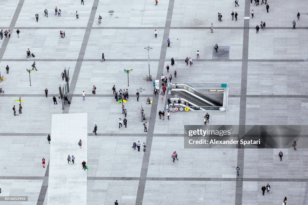 Crowds of people walking on the city square in La Defense - business financial district, Paris, France