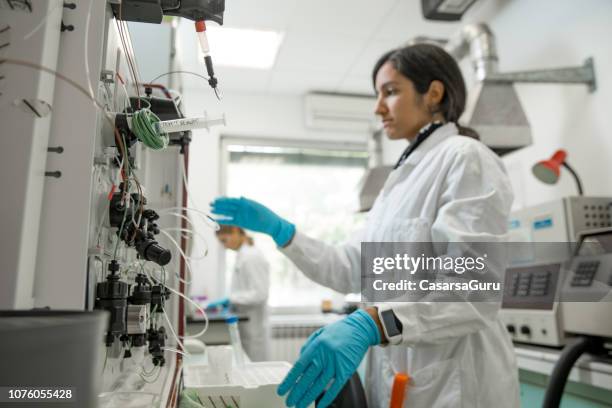 young female researcher using fast protein liquid chromatography (fplc), for purification of proteins in the bacterial lysate - purity stock pictures, royalty-free photos & images