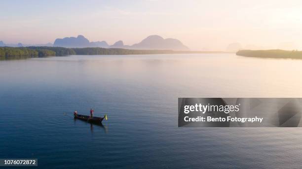 aerial view of fisherman on the traditional long tail boat in "sam chong tai" fisherman village in phang nga, thailand. - longtail boat stock pictures, royalty-free photos & images