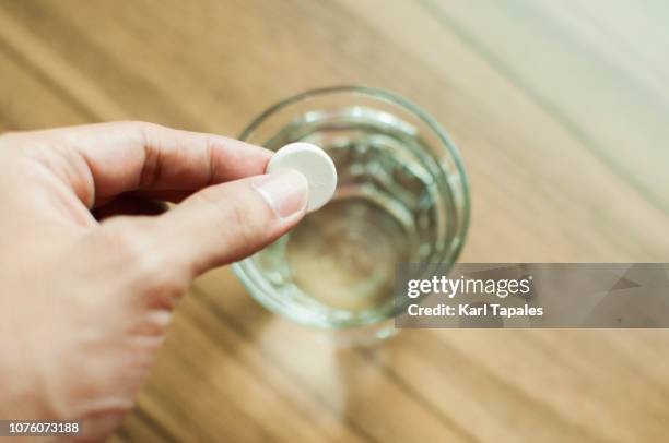 a young man is holding a medicine tablet - 分解 ストックフォトと画像