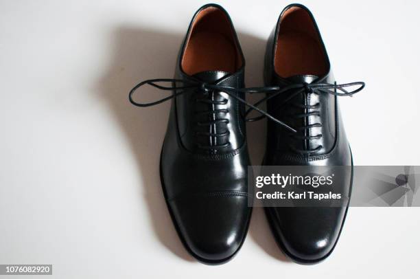 a pair of black cap toe shoes - black shoe stock pictures, royalty-free photos & images