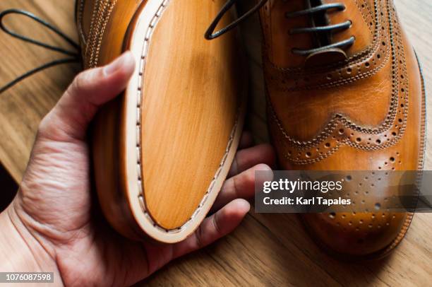 a close-up of a pair of men's shoes - dress shoes stock pictures, royalty-free photos & images