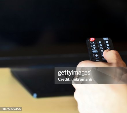 Cropped Hand Of Man Operating Remote At Home High-Res Stock Photo ...