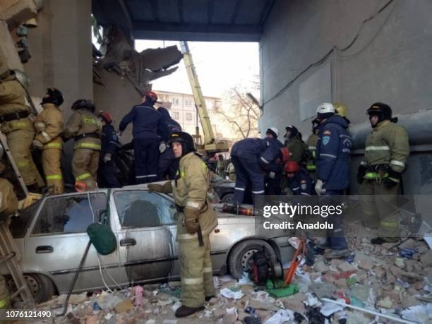 Russian rescue workers remove debris after a gas explosion in an apartment building in the city of Magnitogorsk, Chelyabinsk region, Russia, 31...