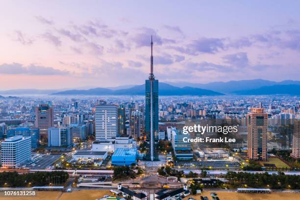 panorama of fukuoka tower aerial view from drone at sunset along with momochi beach, fukuoka prefecture, japan - kyushu stock-fotos und bilder