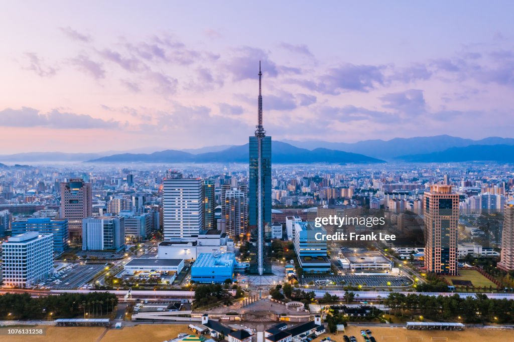 Panorama of Fukuoka tower aerial view from drone at sunset along with Momochi beach, Fukuoka prefecture, Japan