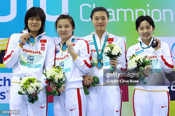Qian Chen, Yi Tang, Jing Liu and Qianwei Zhu of China pose with their Gold medals after winning the Women's 4x200m Freestyle final during day one of...