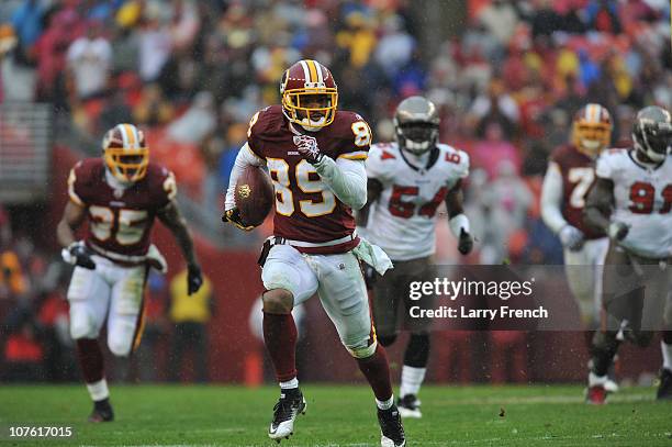 Santana Moss of the Washington Redskins runs the ball after a catch during the game against the Tampa Bay Buccaneers at FedExField on December 12,...