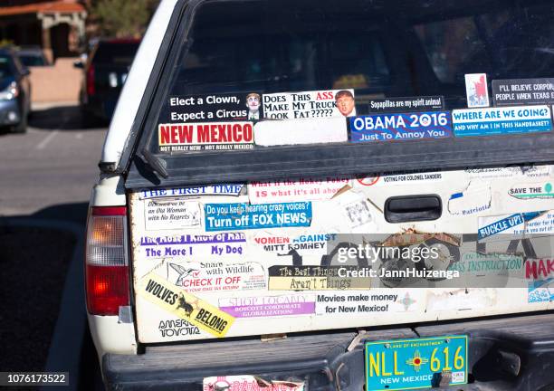 santa fe, nm: pickup truck covered with bumper stickers - bumper sticker stock pictures, royalty-free photos & images