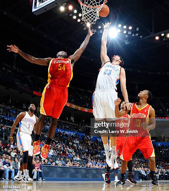 Byron Mullens of the Oklahoma City Thunder goes for a rebound against Patrick Patterson of the Houston Rockets during the game at the Oklahoma City...