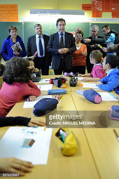 France's Education Minister Luc Chatel , flanked by Saint-Ouen communist Party mayor, Jacqueline Rouillon, and Seine-Saint-Denis prefect Christian...