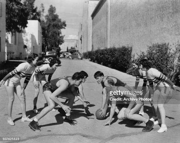 Members of the Motion Picture Studio All-Stars basketball team play an informal game with MGM actresses at MGM Studios, Hollywood, California, USA,...