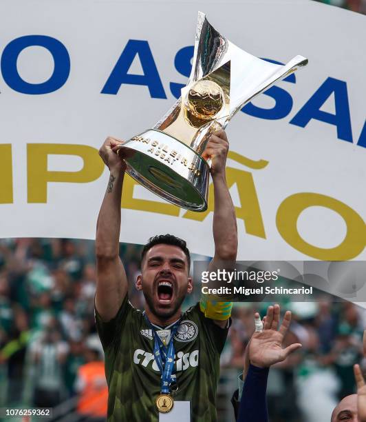 Bruno Henrique of Palmeiras holds the trophy after winning the Brasileirao 2018 after the match against Vitora at Allianz Parque on December 02, 2018...