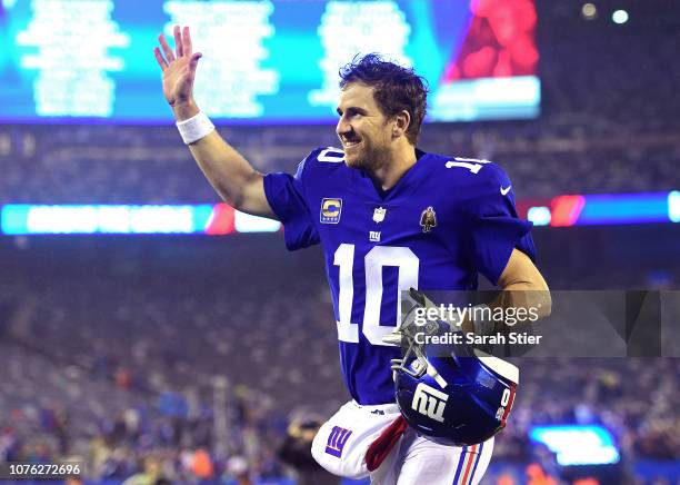 Eli Manning of the New York Giants runs off the field after his teams 30-27 win over the Chicago Bears at MetLife Stadium on December 02, 2018 in...