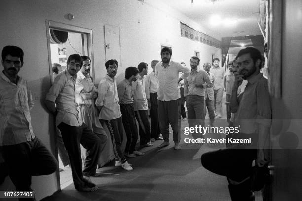 Political prisoners, gather in the corridor, at the high security Evin Prison in Tehran, Iran, 10th February 1986.