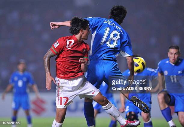Indonesian's player Irfan Bachdim vies for a ball with Philippines player's Christoper Robert during the first of the two round semi final games of...