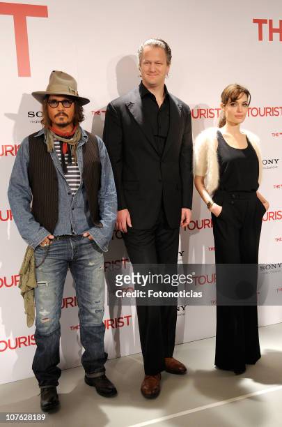 Actor Johnny Depp, director Florian Henckel Von Donnersmarck and actress Angelina Jolie attend 'The Tourist' photocall at the Villamagna Hotel on...