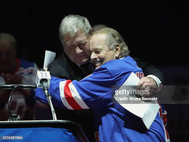 The New York Rangers retire the jersey of Vic Hadfield as he is embraced by Rod Gilbert during a ceremony at Madison Square Garden on December 2,...