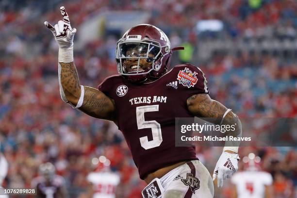 Trayveon Williams of the Texas A&M Aggies celebrates after a touchdown against the North Carolina State Wolfpack during the second half of the...