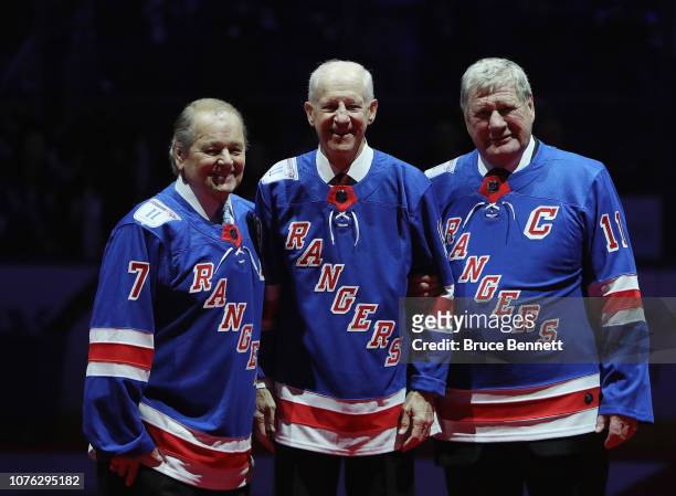 The jersey of former New York Ranger Vic Hadfield is raised to the rafters to join his linemates Rod Gilbert and Jean Ratelle at Madison Square...