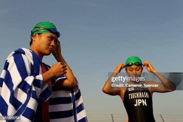 Yi Zhang of China and Akane Tsuchihashi of Japan prepare for the start of the Women's Triathlon event at North Al Hail during day nine of the 2nd...