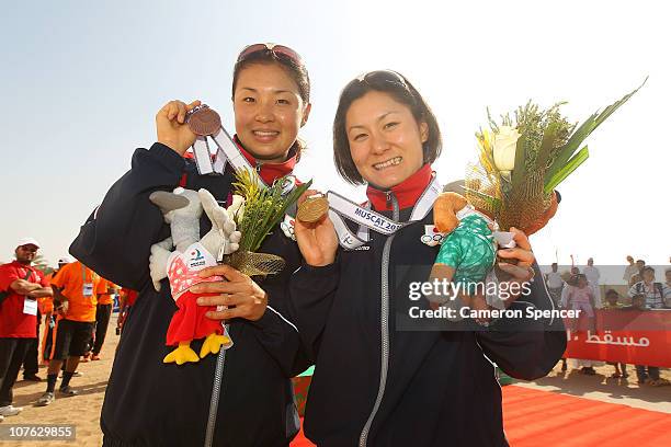 Akane Tsuchihashi of Japan and Juri Ide of Japan pose with their medals following the Women's Triathlon event at North Al Hail during day nine of the...