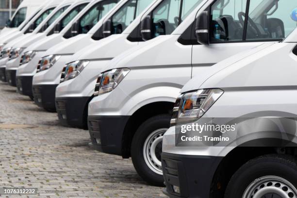 delivery vans parked on the parking - van stock pictures, royalty-free photos & images