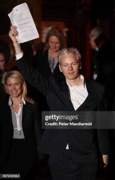 WikiLeaks founder Julian Assange waves legal papers as he leaves The High Court on December 16, 2010 in London, England. Julian Assange has been...