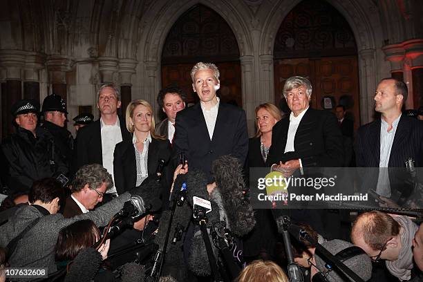 WikiLeaks founder Julian Assange stands with his legal team and speaks to reporters as he leaves The High Court on December 16, 2010 in London,...